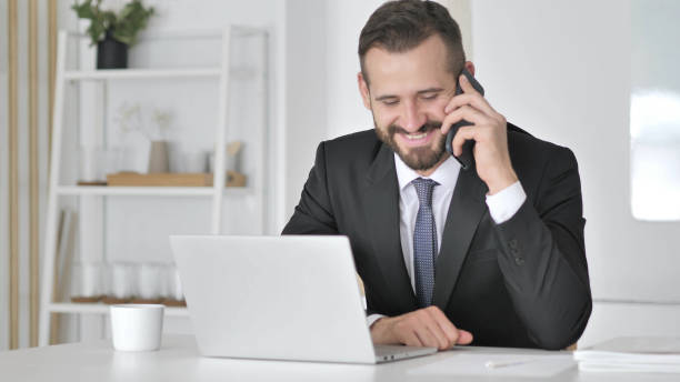 "Professional insurance agent working at a desk, utilizing technology and communication skills."