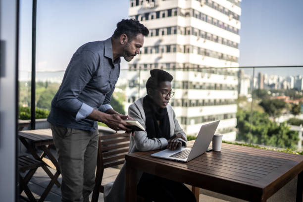 : A diverse group of remote insurance agents working together on laptops, creating a collaborative and inclusive work environment.