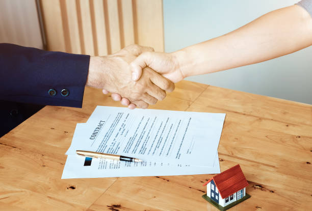 a photo of an Independent Insurance Agent representing a professional persona handling documents and shaking hands to depict the aspects of the job.