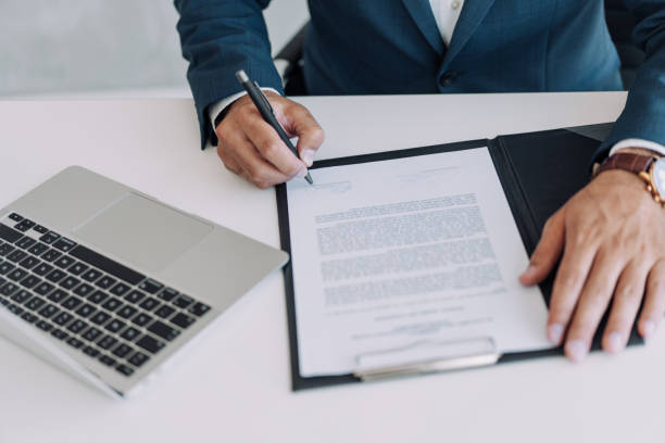 Successful insurance agent taking notes at their desk.
