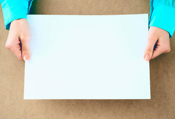 Holding a whitepPaper highlighting the company's recruitment drive.