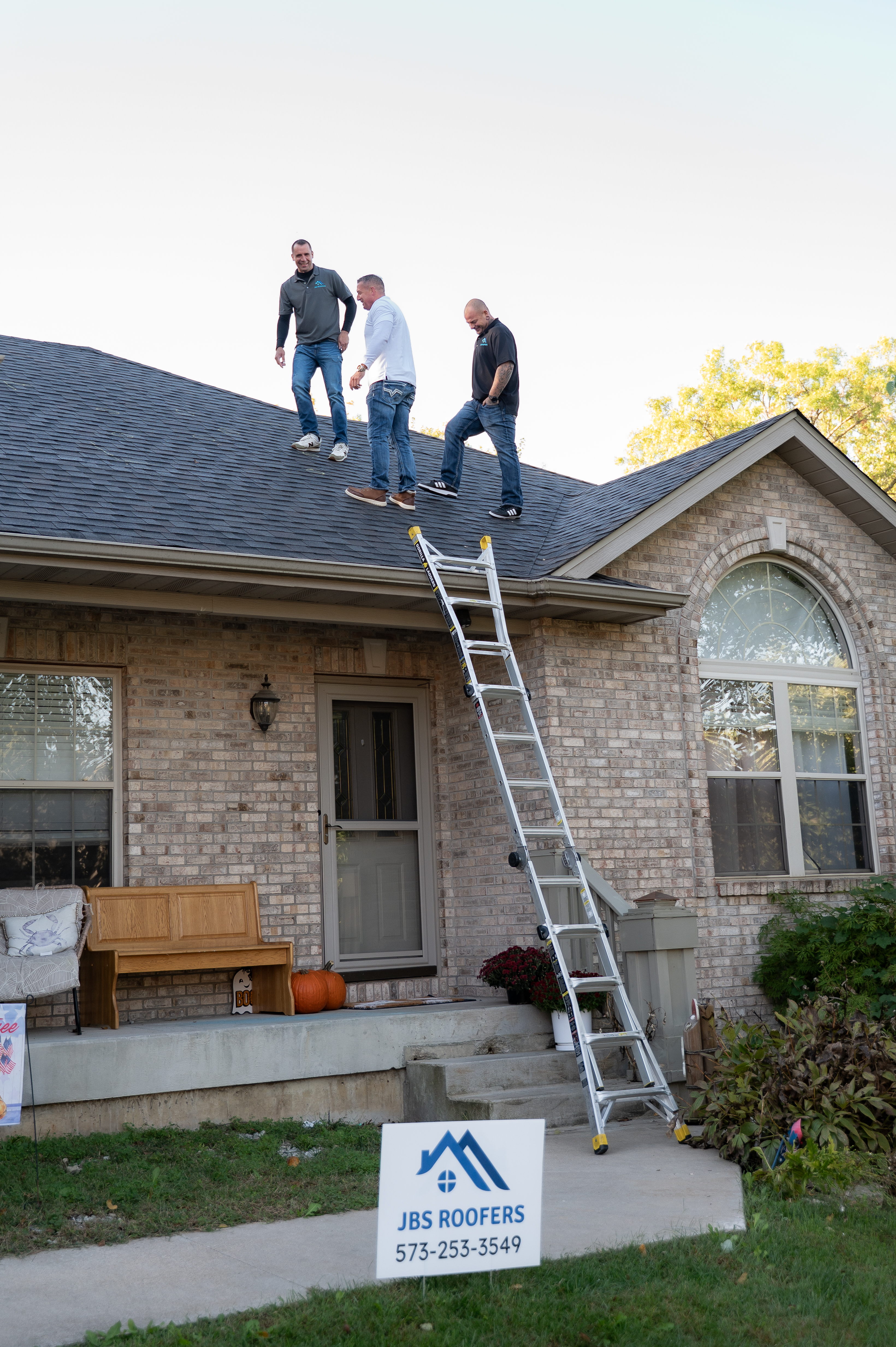 Roof repair with ladder against house