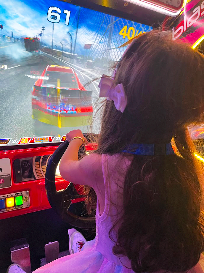 Girl playing an arcade game at Game Time in Orlando Girl playing an arcade game at Game Time in Orlando