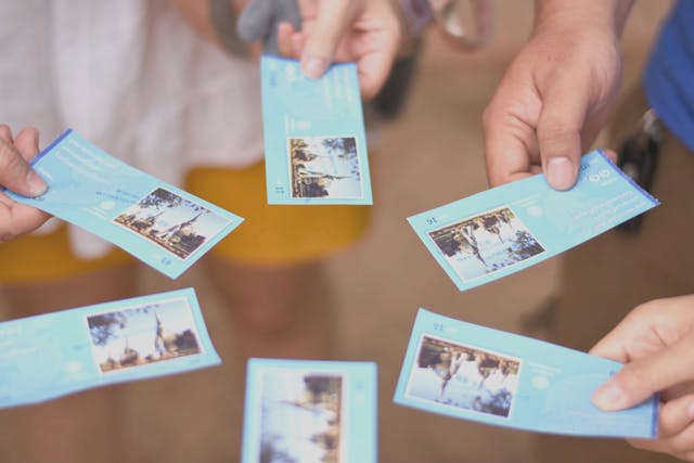 Close-up of a group of people holding tickets Close-up of a group of people holding tickets