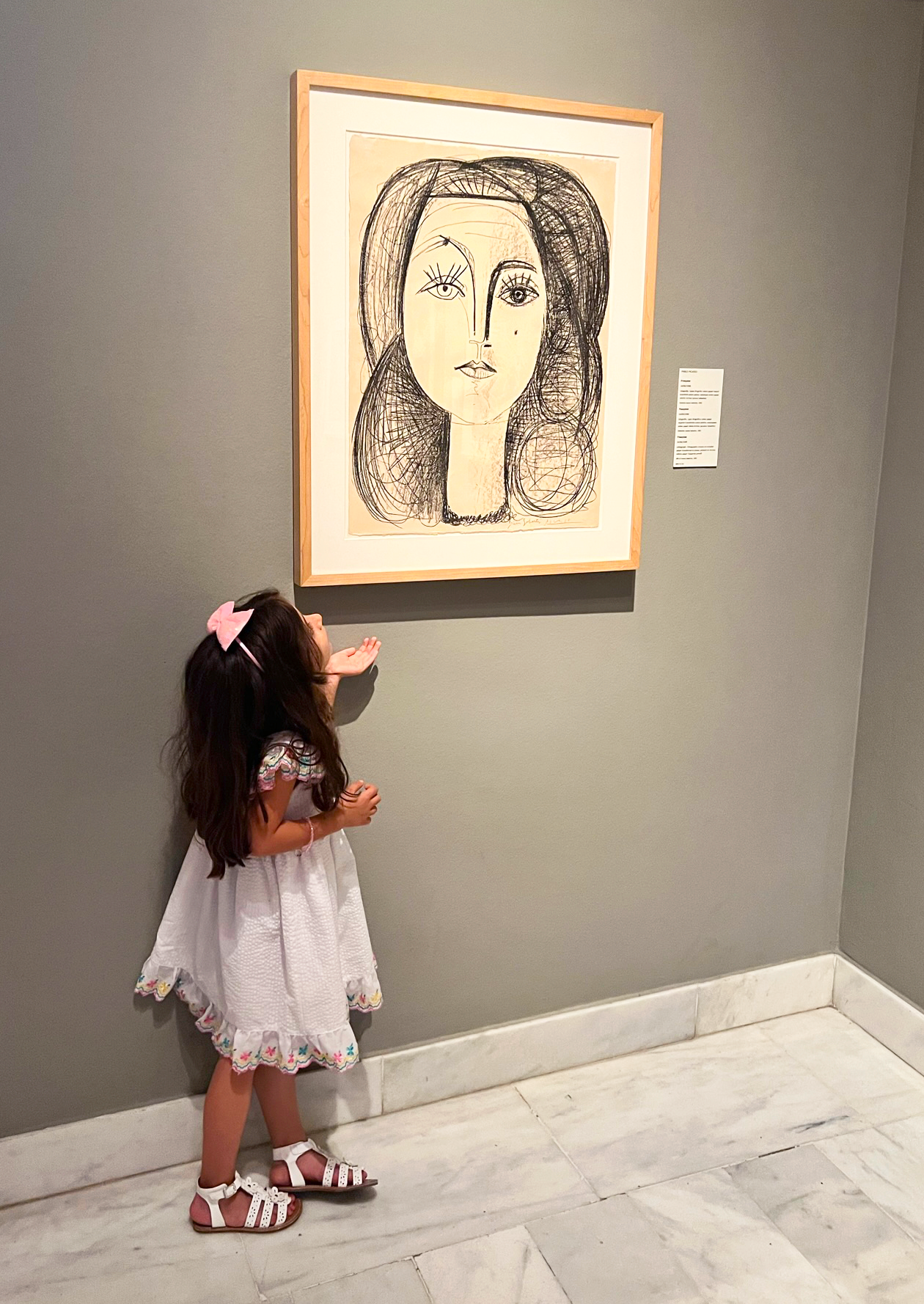 Girl looking at a Picasso painting at the Picasso Museum Girl looking at a Picasso painting at the Picasso Museum