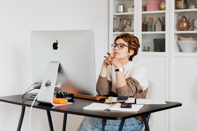Focused woman reading information on a computer Focused woman reading information on a computer