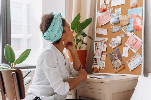 Woman looking at her vision board Woman looking at her vision board