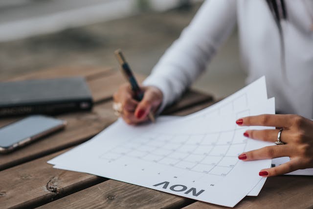 Cropped woman filling the calendar Cropped woman filling the calendar