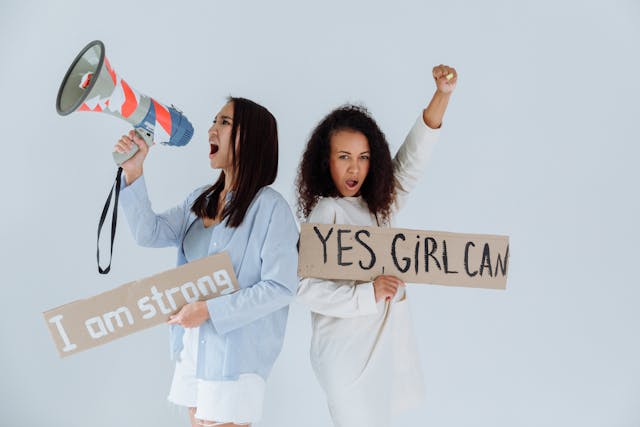 Women holding placards with positive messages Women holding placards with positive messages