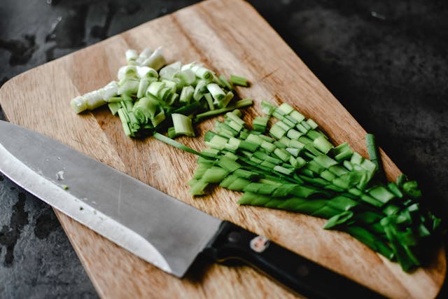 Sliced vegetables on wooden cooking board Sliced vegetables on wooden cooking board