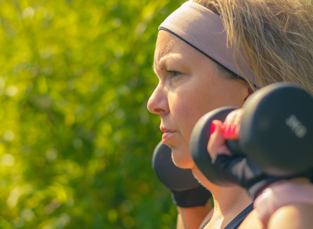 Woman exercising with light weights Woman exercising with light weights