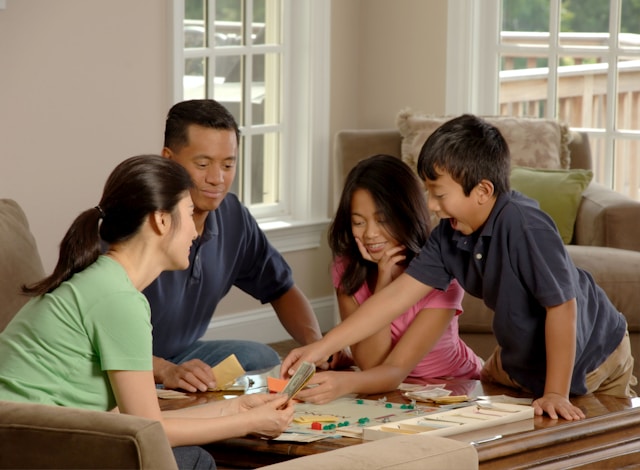 Family playing board game Family playing board game