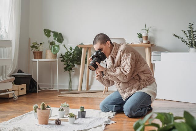 Woman taking photos of house plants Woman taking photos of house plants