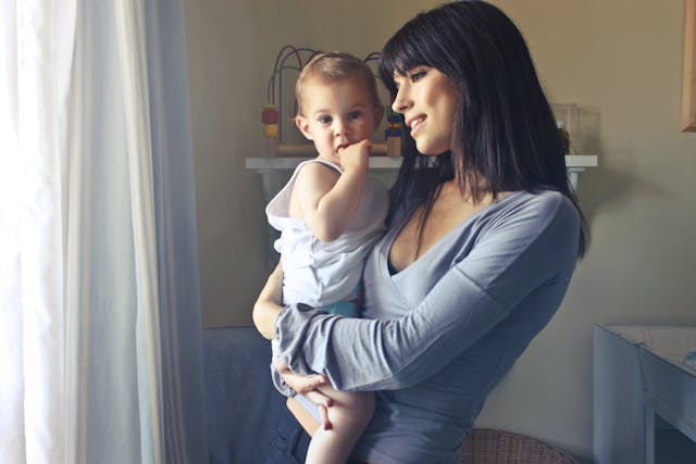 Woman holding her baby at home