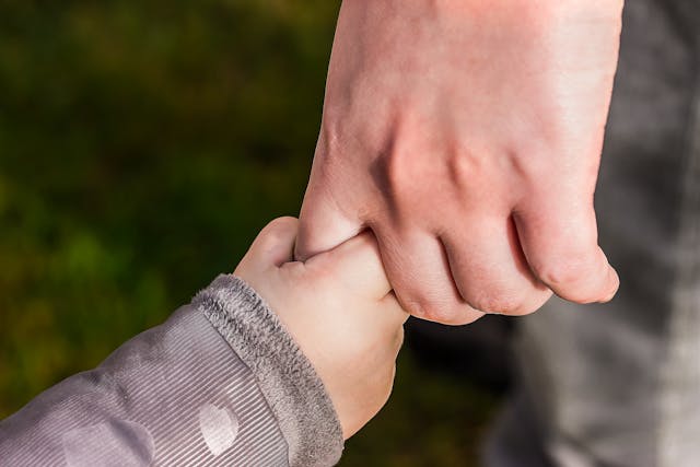 Child and mom holding hands