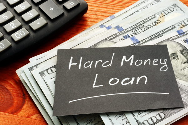 Hard money loan cash financing concept with calculator and dollars – ideal for fast property deals Hard money loan cash financing concept with calculator and dollars – ideal for fast property deals