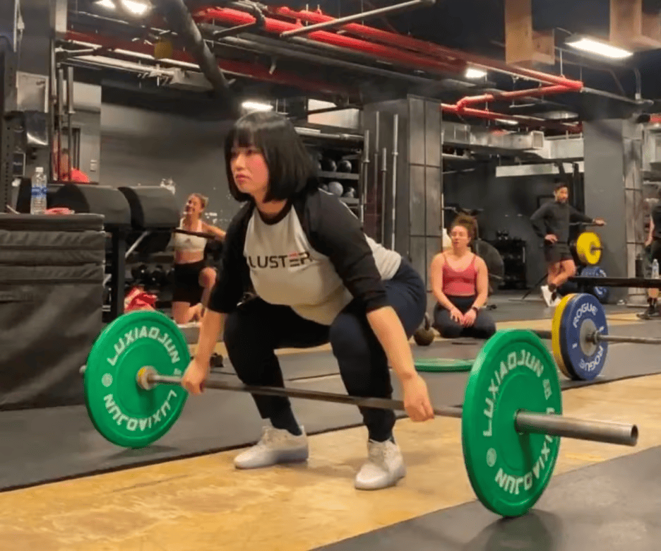 Female weightlifter performing a deadlift in a professional gym with Luxiaojun weight plates, showcasing strength training and Olympic lifting techniques. Female weightlifter performing a deadlift in a professional gym with Luxiaojun weight plates, showcasing strength training and Olympic lifting techniques.