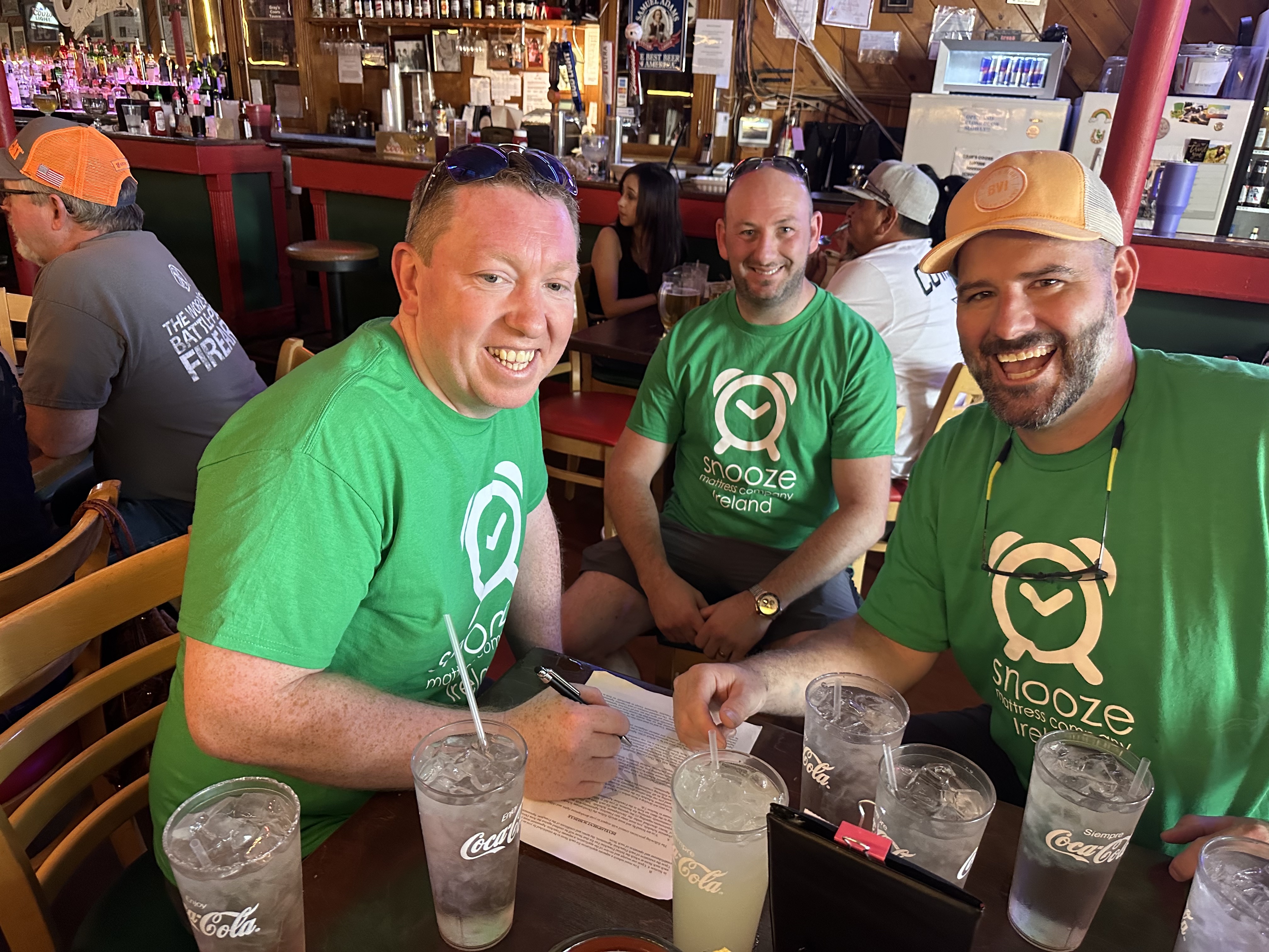 Matt Smith, CEO and Founder of Snooze Mattress Co., sits with John Griffin and Kenneth Sexton, new Snooze Mattress franchisees from Ireland.