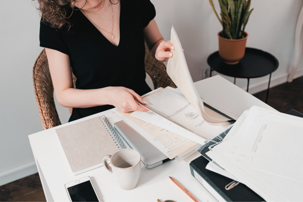 woman looking through paper work woman looking through paper work