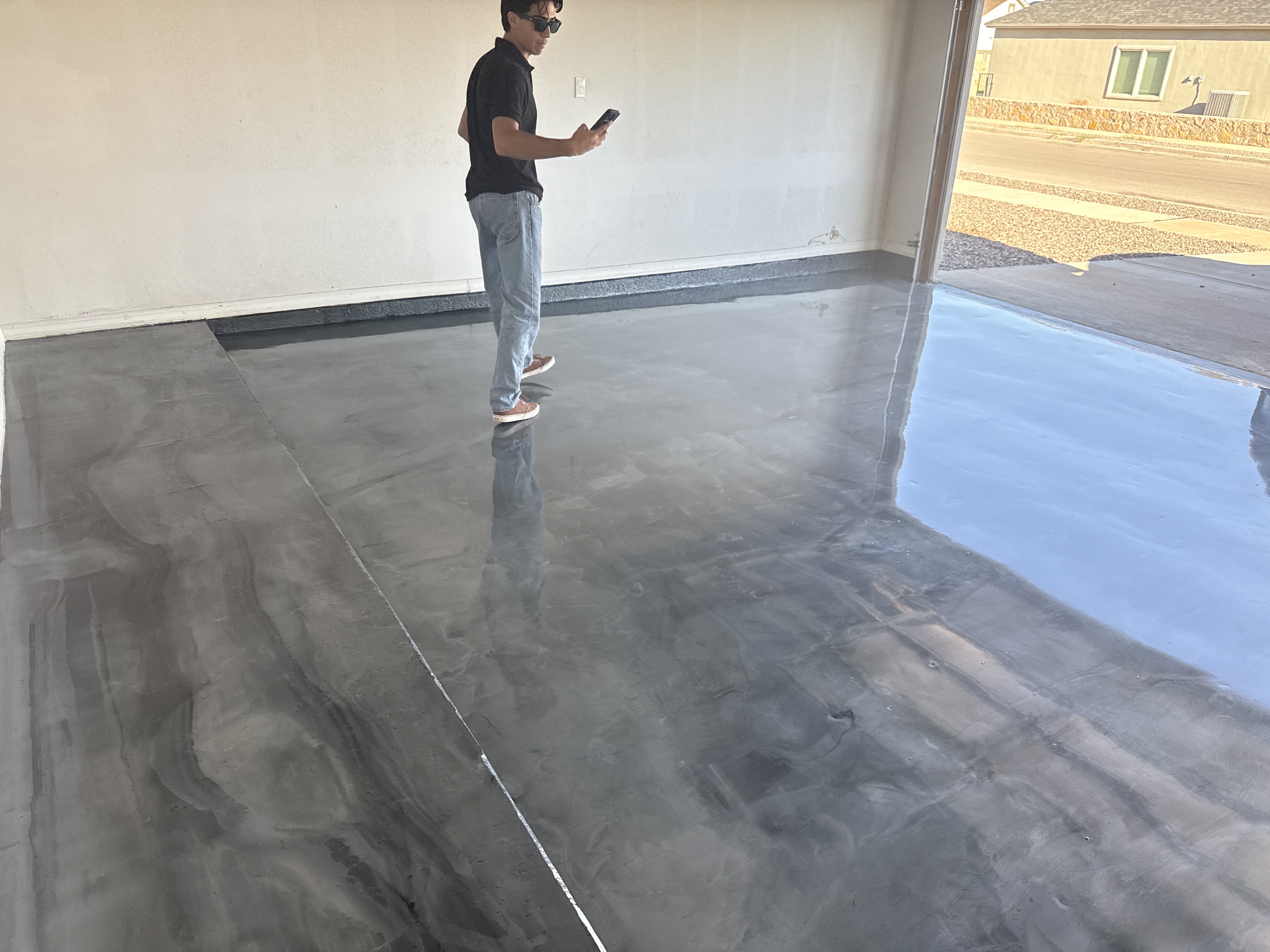 Freshly installed epoxy floor with deep metallic swirls in a clean garage