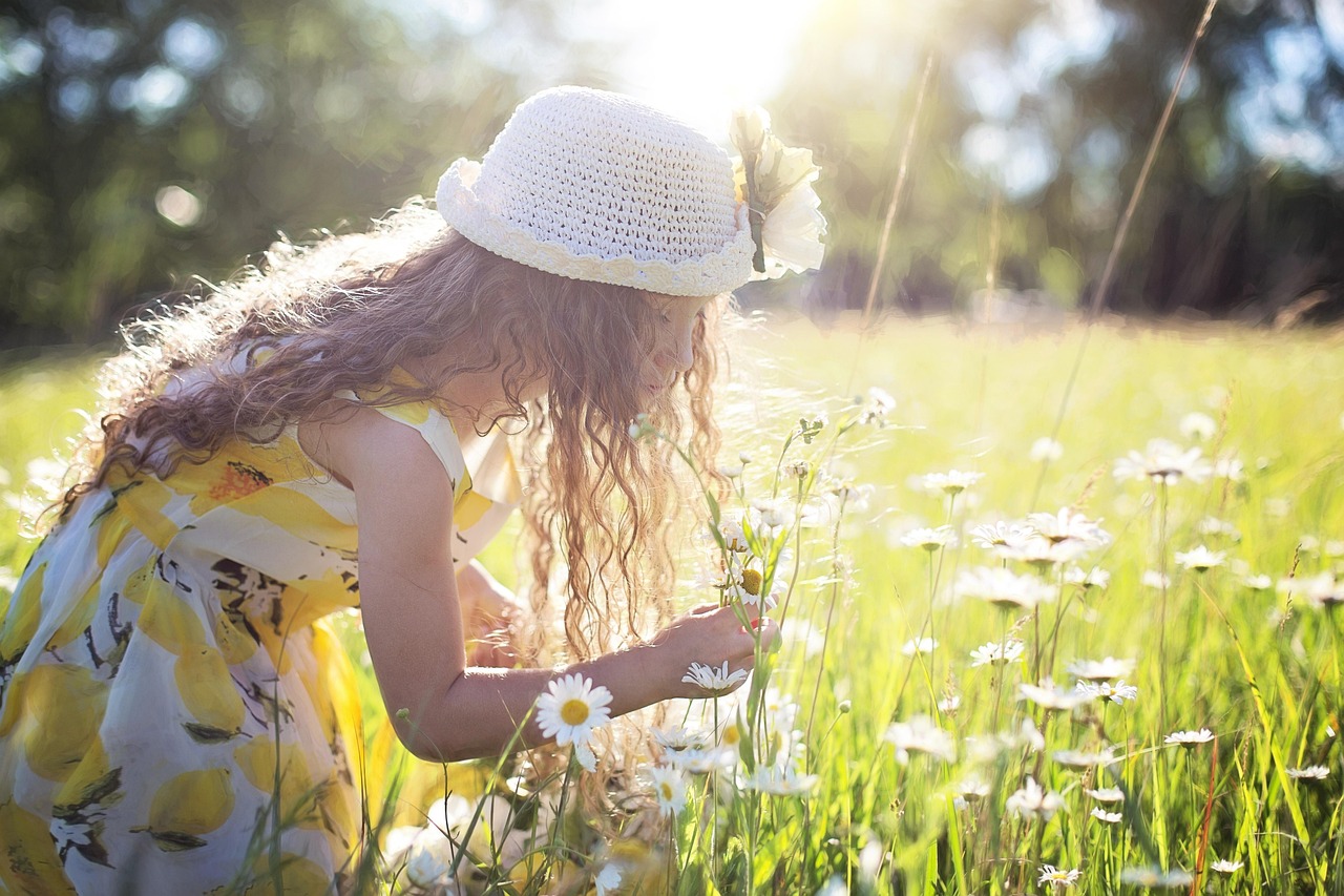 child picking wildflowers