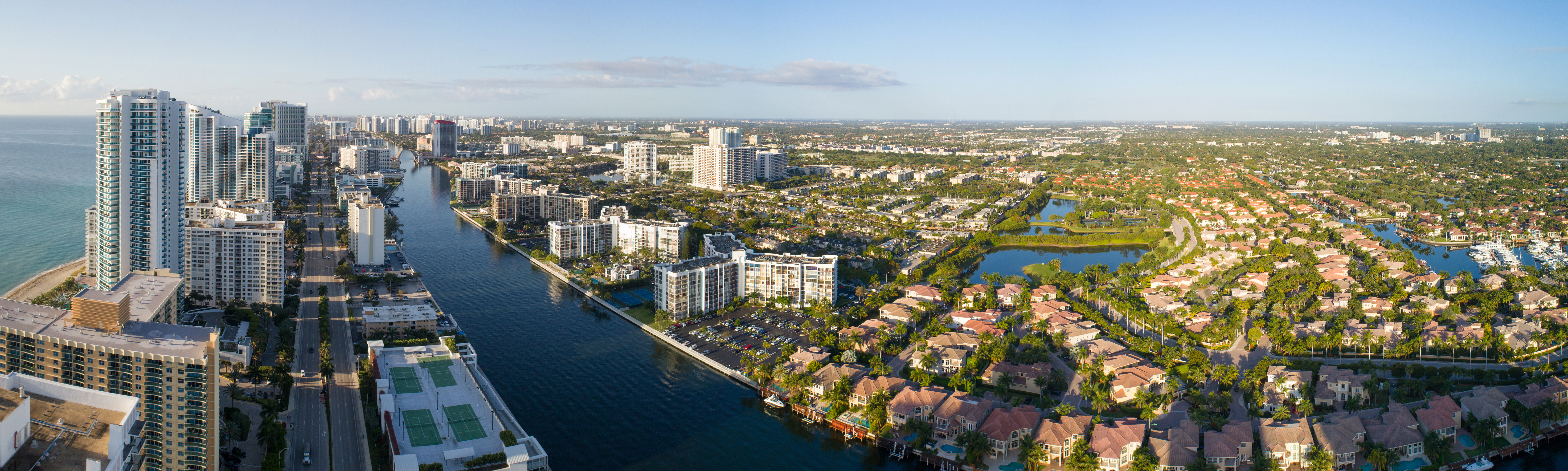 Aerial view of Hollywood Lakes neighborhood in Hollywood, Florida with waterfront homes, canals, and high-rise condos near the beach.