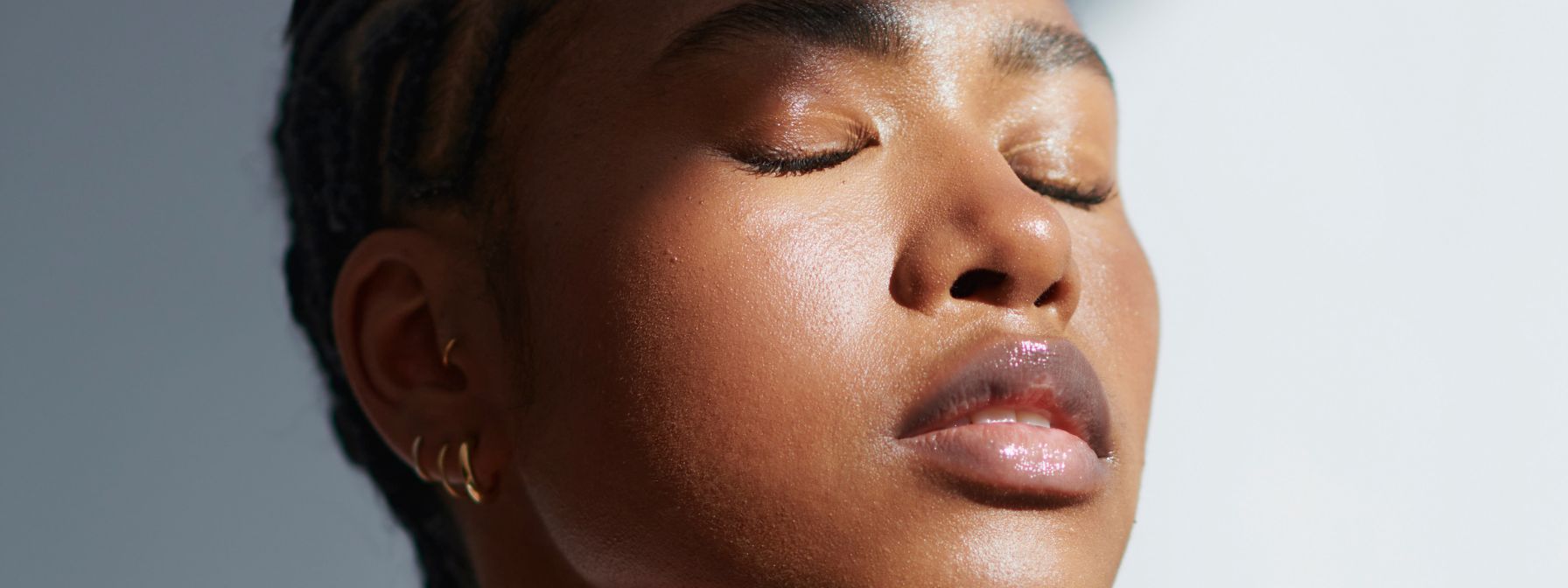 Close-up of a person with glowing, radiant skin and closed eyes, highlighting a smooth complexion and healthy glow in natural light. Close-up of a person with glowing, radiant skin and closed eyes, highlighting a smooth complexion and healthy glow in natural light.
