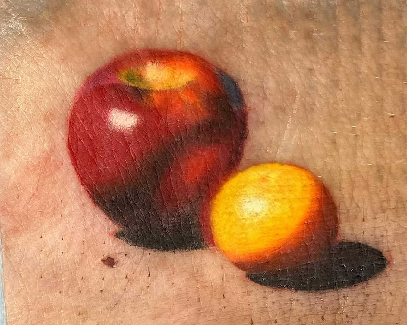 David Cheifetz pig skin tattoo of apple and orange
