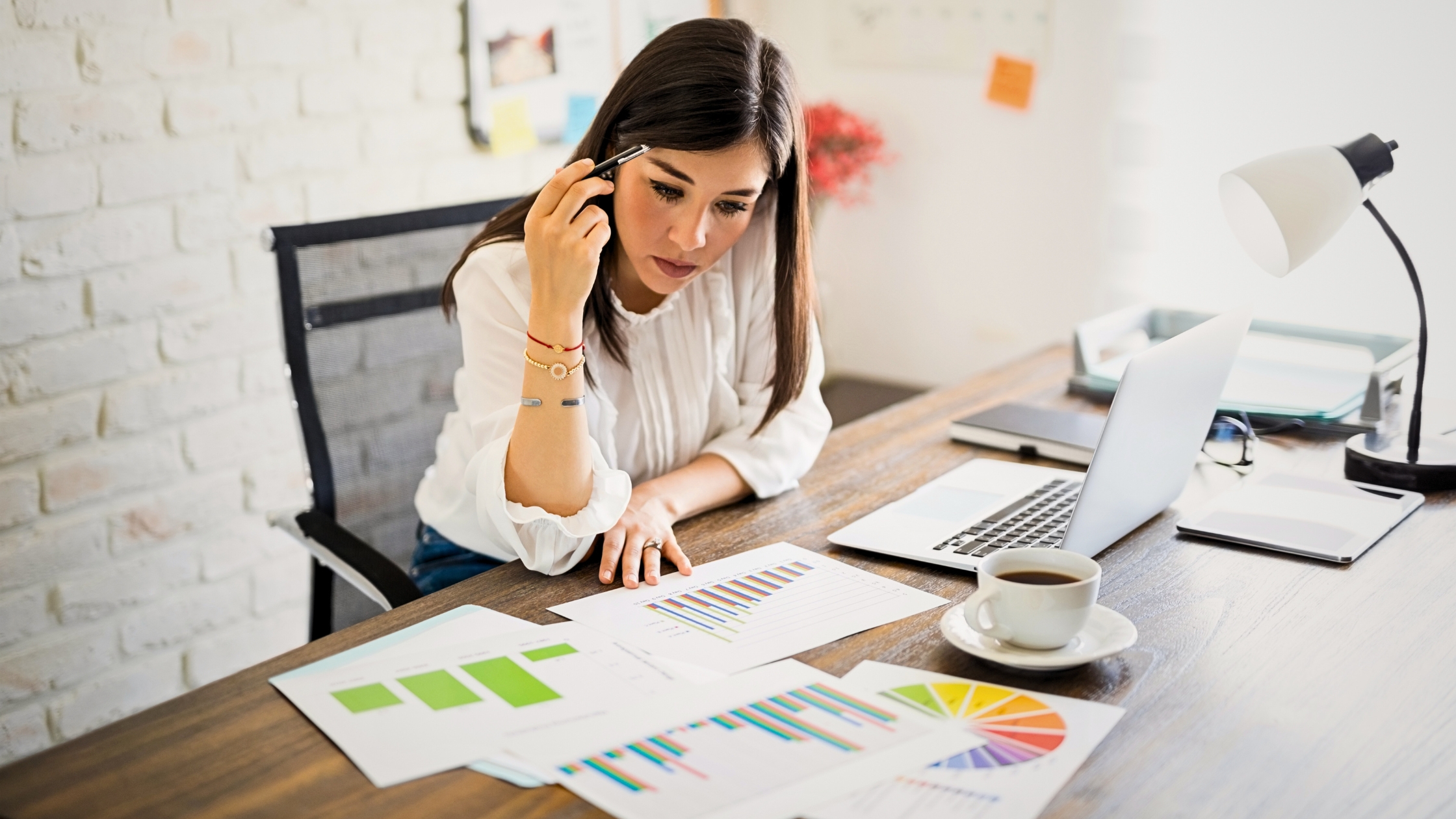 business owner reviewing financial reports on a laptop