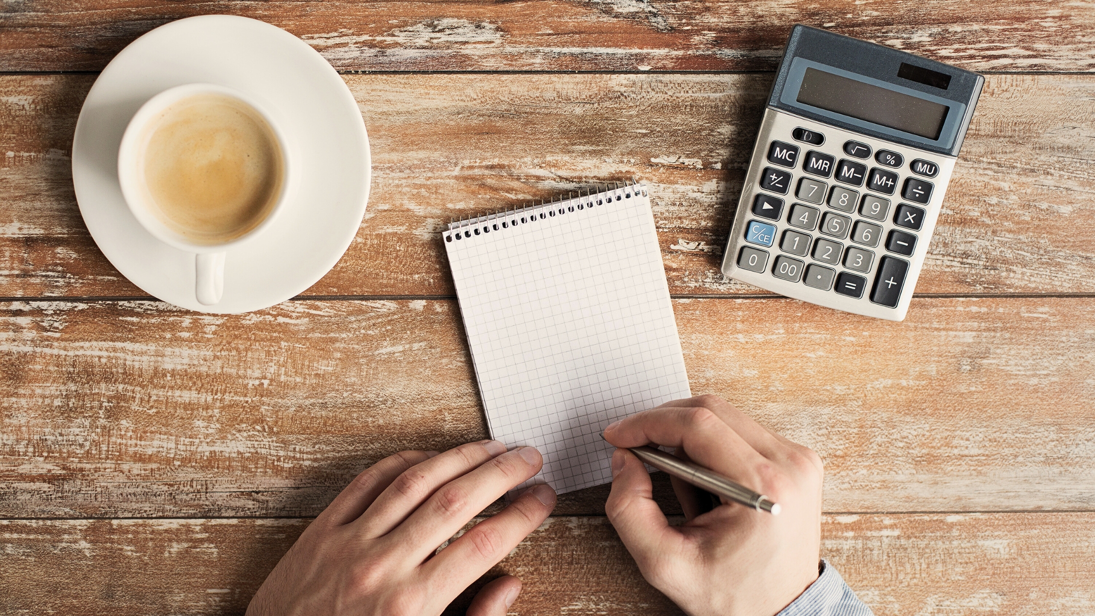  calculator, notebook, and cup of coffee