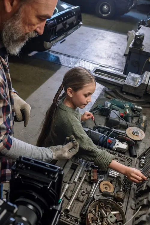 man teaching girl with tools man teaching girl with tools