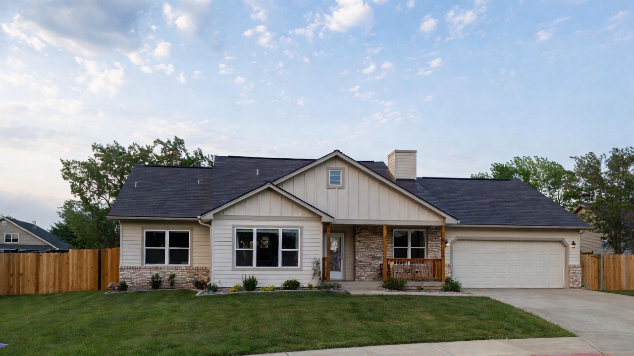 Beautiful ranch-style family home in Grimes, Iowa with stone accents and covered porch