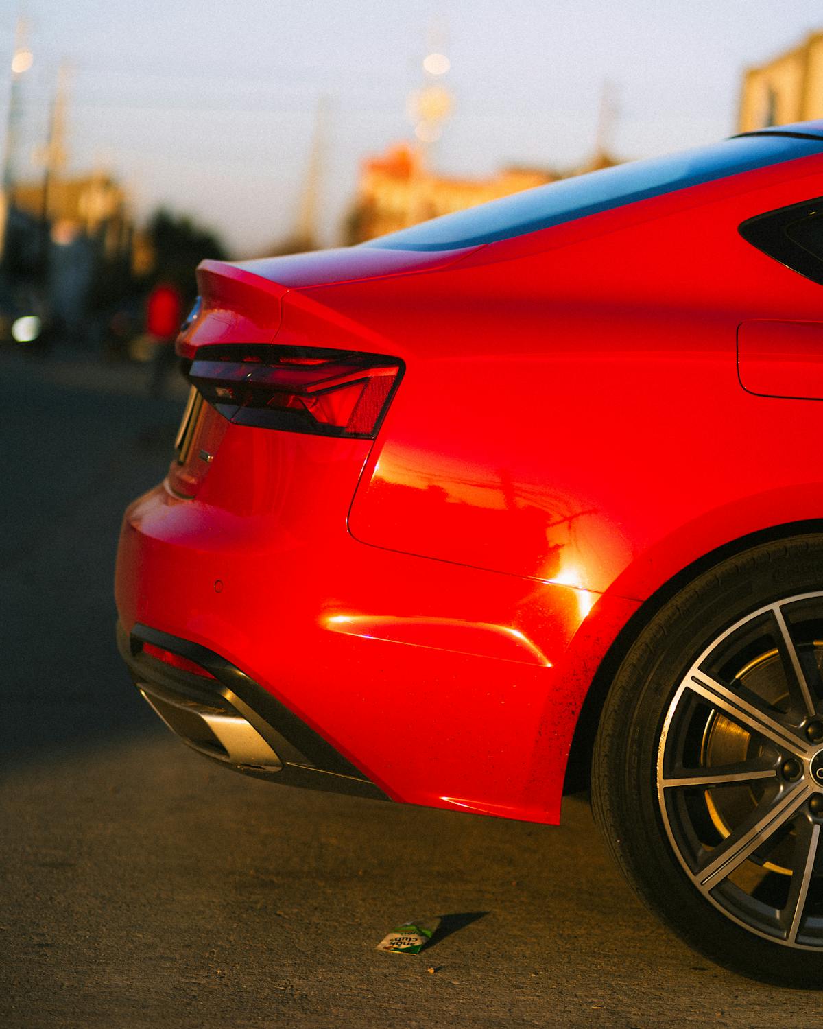 Sunset exterior detailing finish on red sedan with ceramic protection by Houston mobile detailer