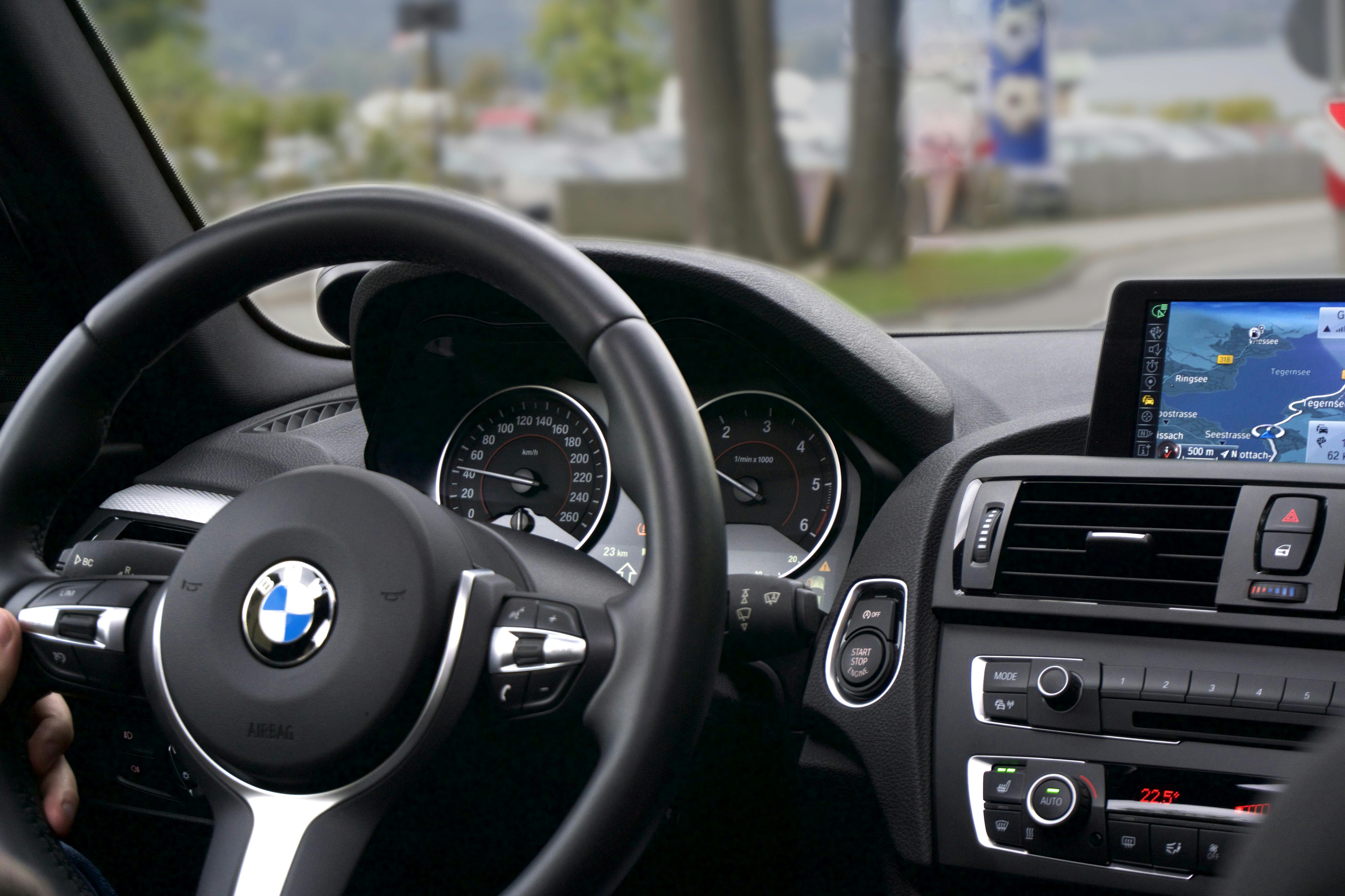 Professional interior detailing on a luxury car dashboard and steering wheel in Houston