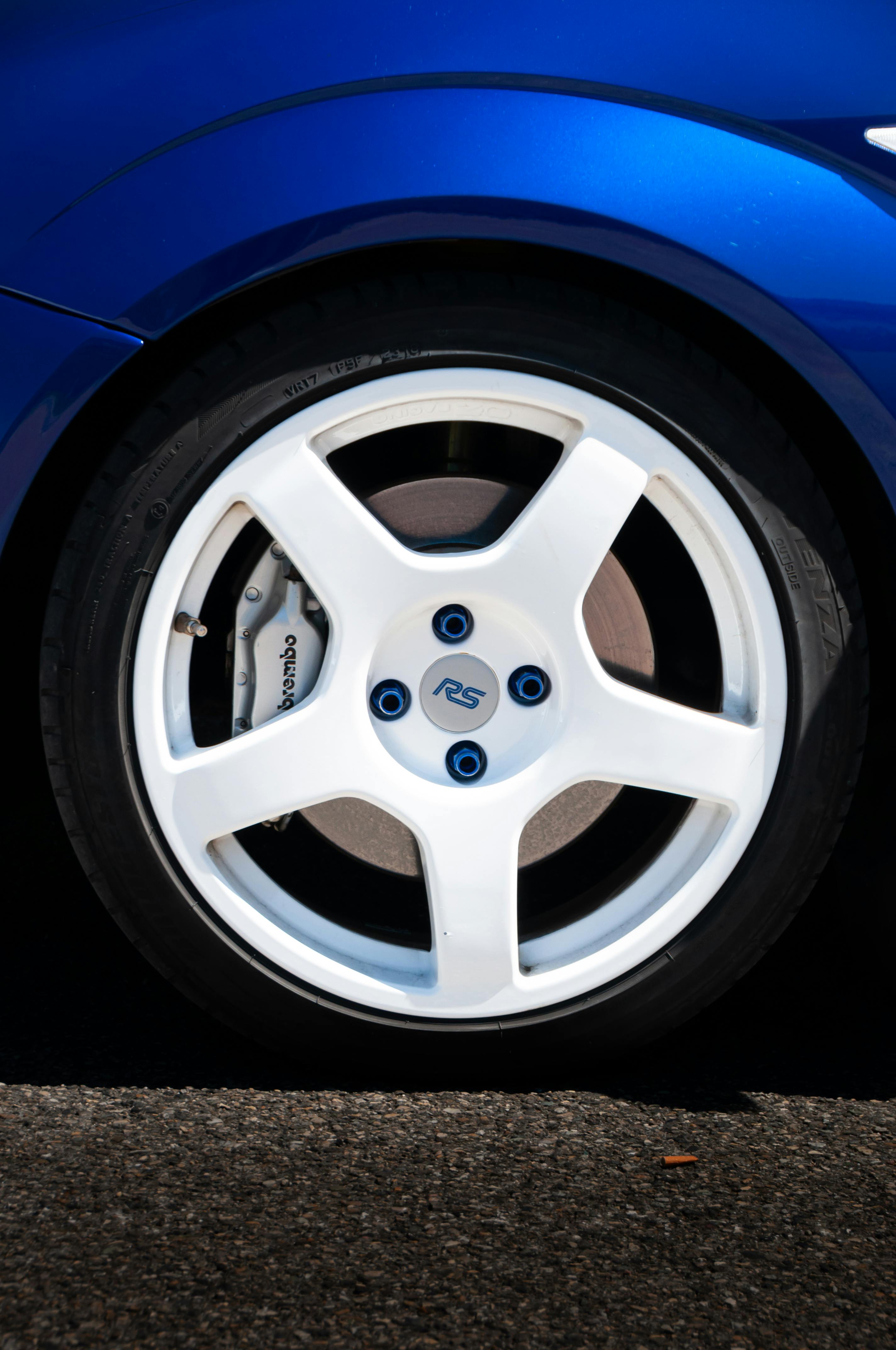 High-gloss ceramic coating protection on blue alloy wheel rim by Houston mobile detailer