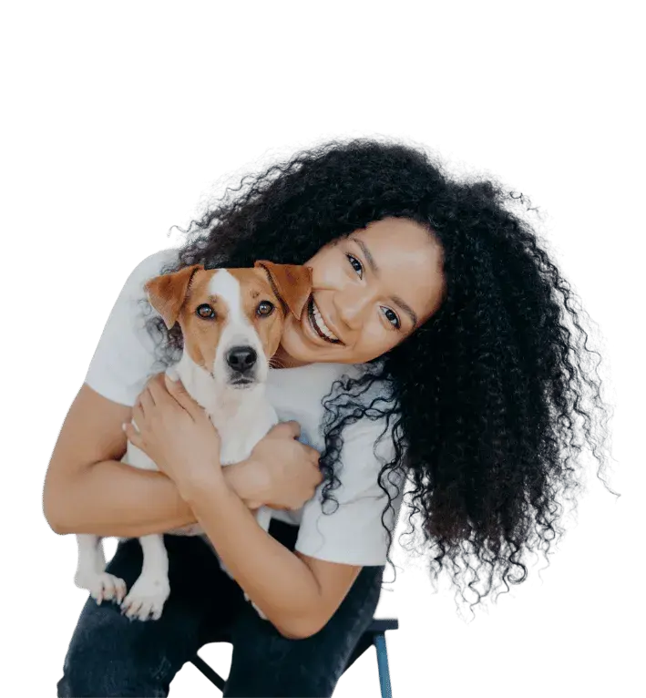 Smiling veterinary professional holding happy Jack Russell terrier, representing clinic growth and client satisfaction