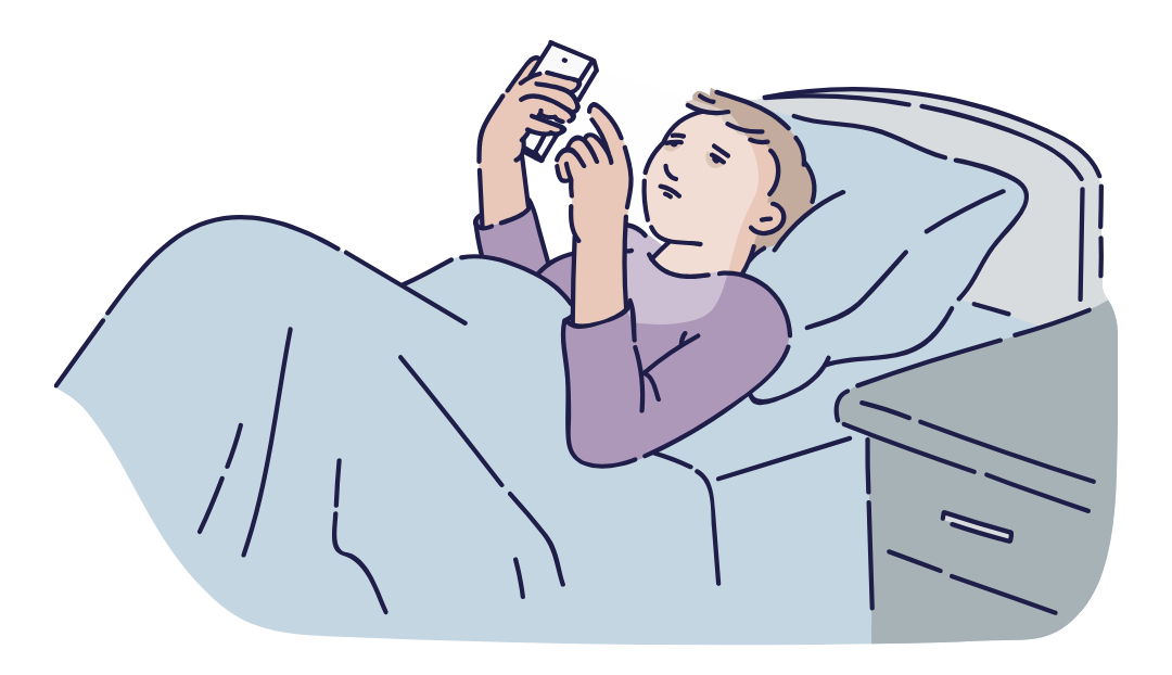 A teen lying in bed scrolling on his phone.