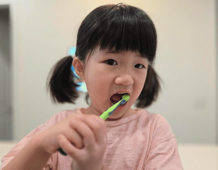 Happy child brushing teeth