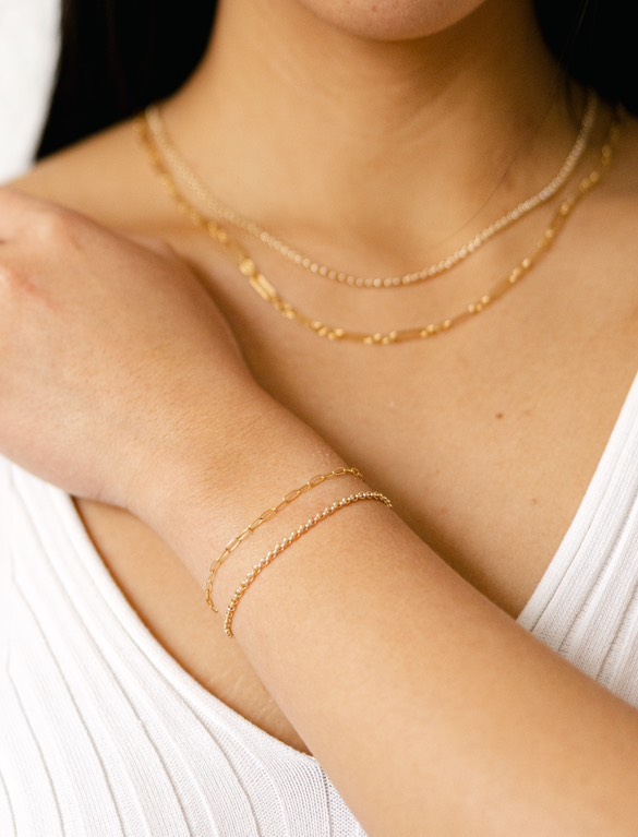 Showcase of Silk N Honey’s permanent jewelry with close-up shots of delicate, gold-filled bracelets and a pop-up experience explanation. Showcase of Silk N Honey’s permanent jewelry with close-up shots of delicate, gold-filled bracelets and a pop-up experience explanation.