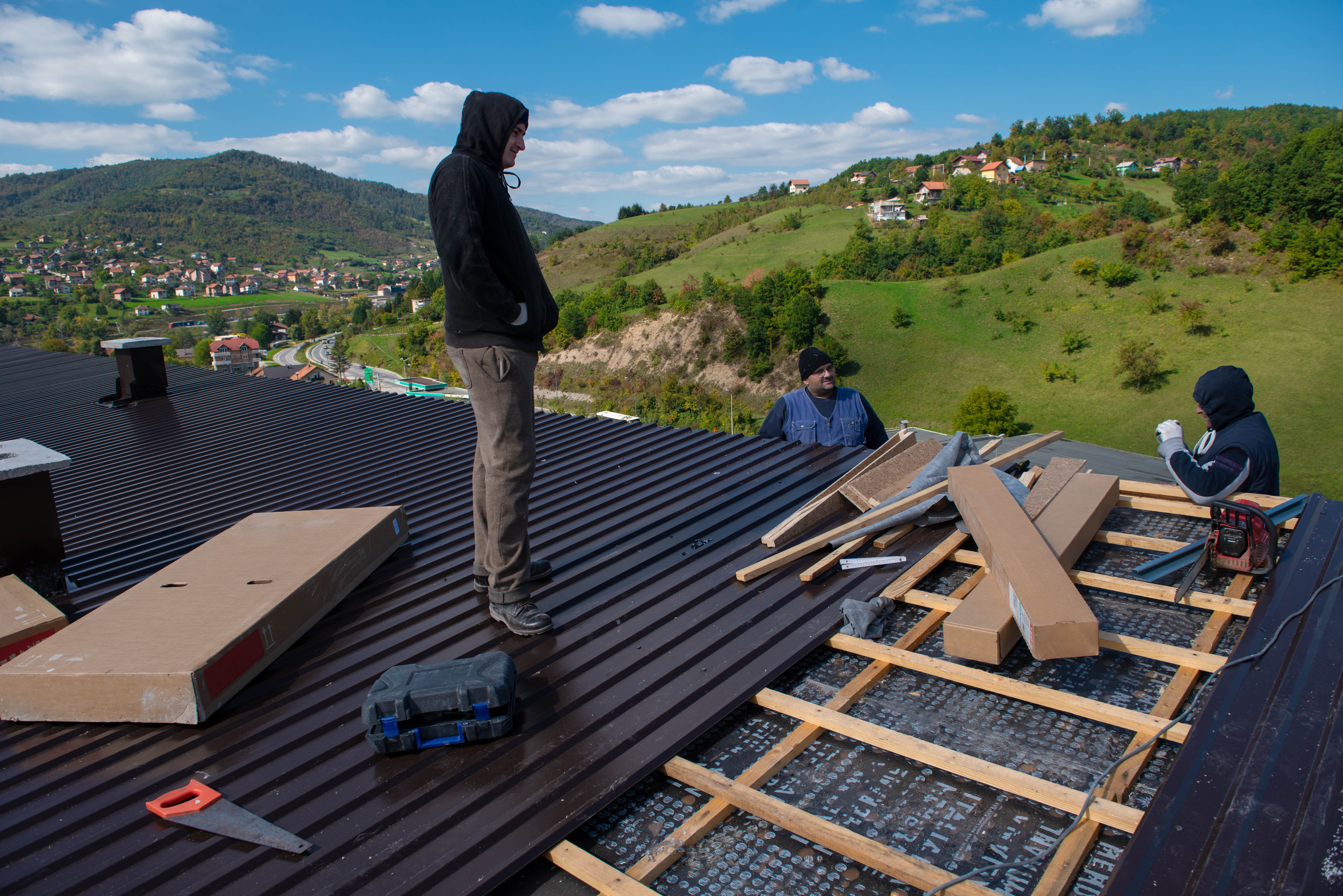 Roofing experts install new metal roof