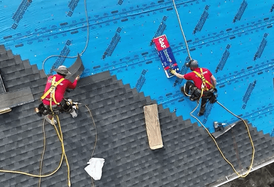 Roofing experts install new roof