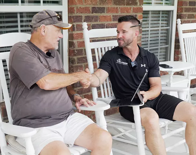 roofer shaking hands with client