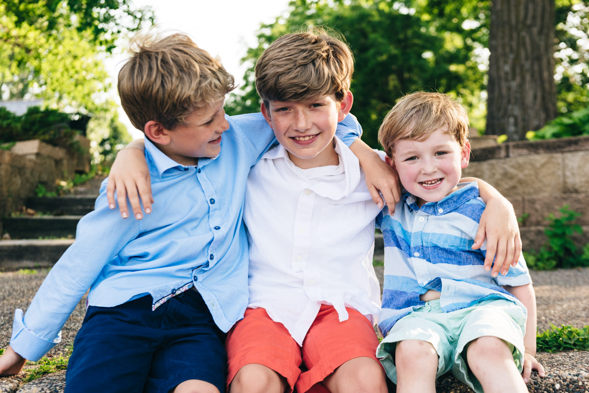 Three kid brothers with arms around each other. Excelsior, MN, family photography.