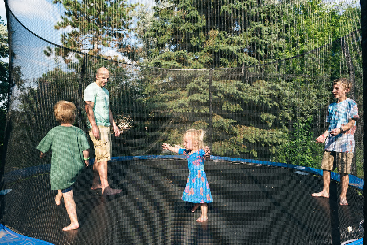 Military homecoming surprise video; photo of family on trampoline.