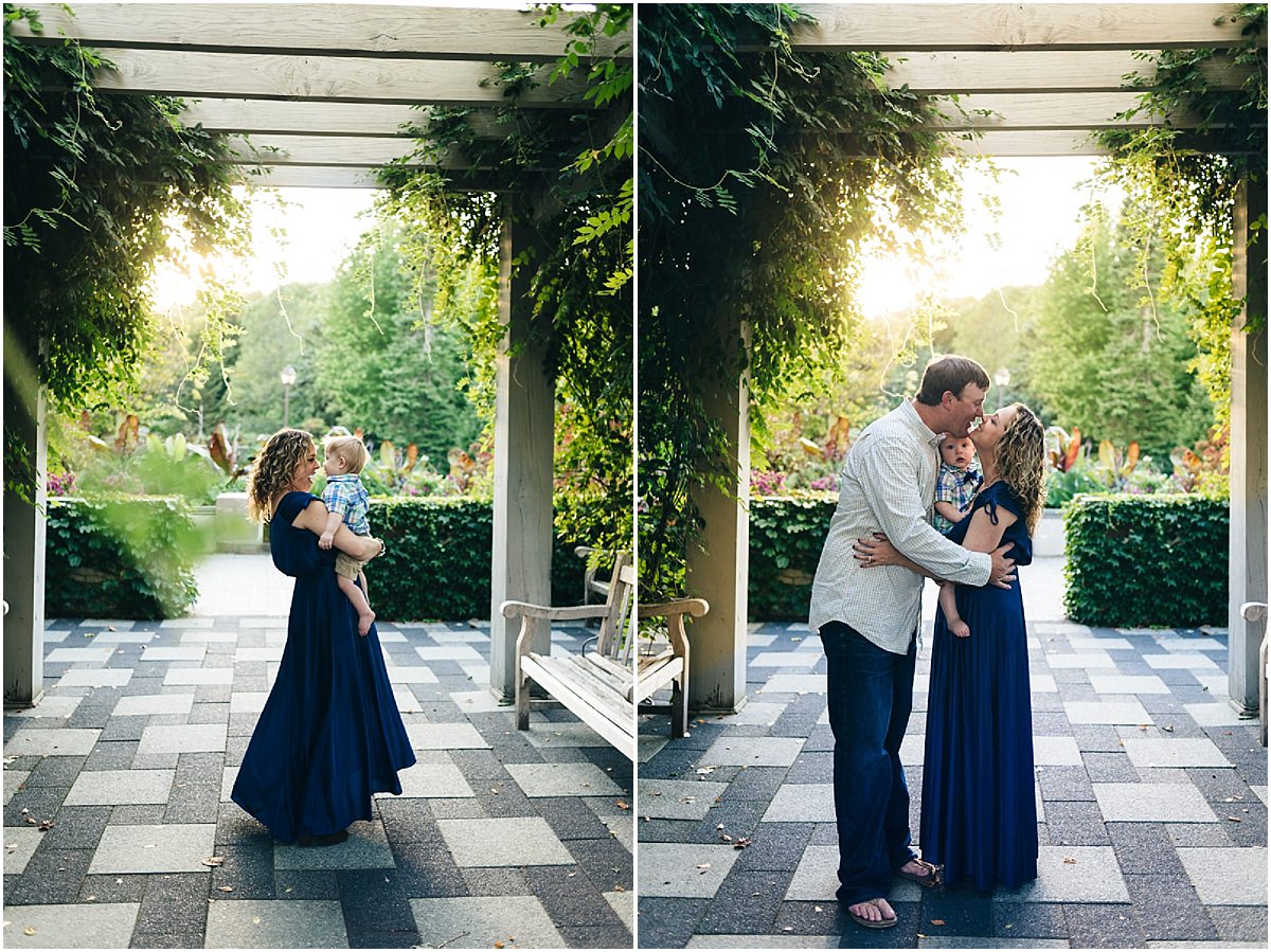 Mother, father and son portraits under an arch during a sunset session.