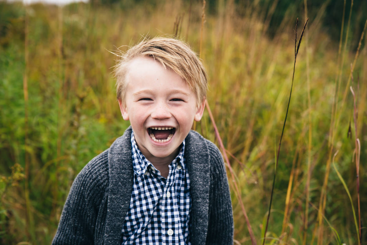 Little boy laughs during Lake Elmo Park photography session.