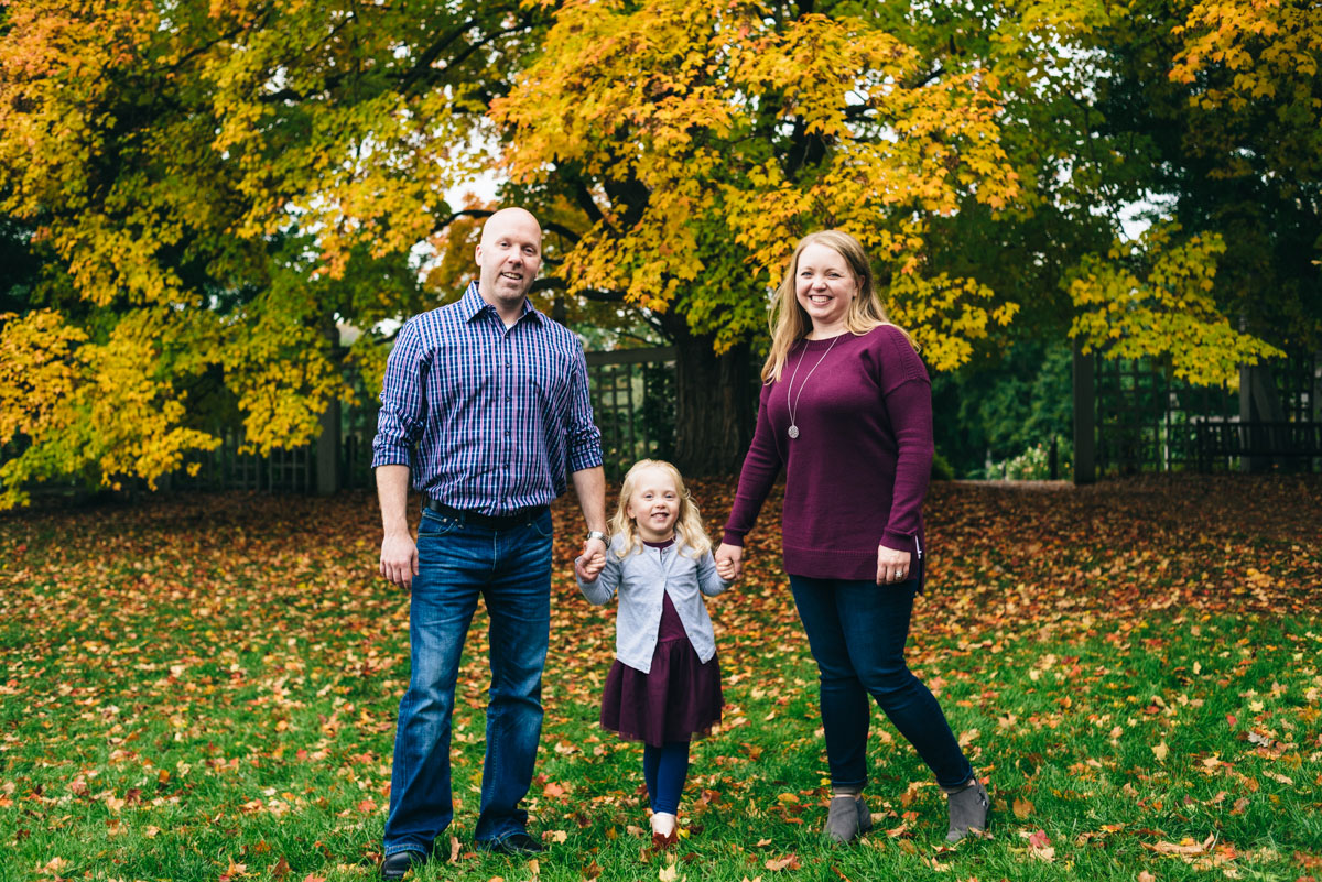 Family poses in front of yellow tree. MN Landscape Arboretum