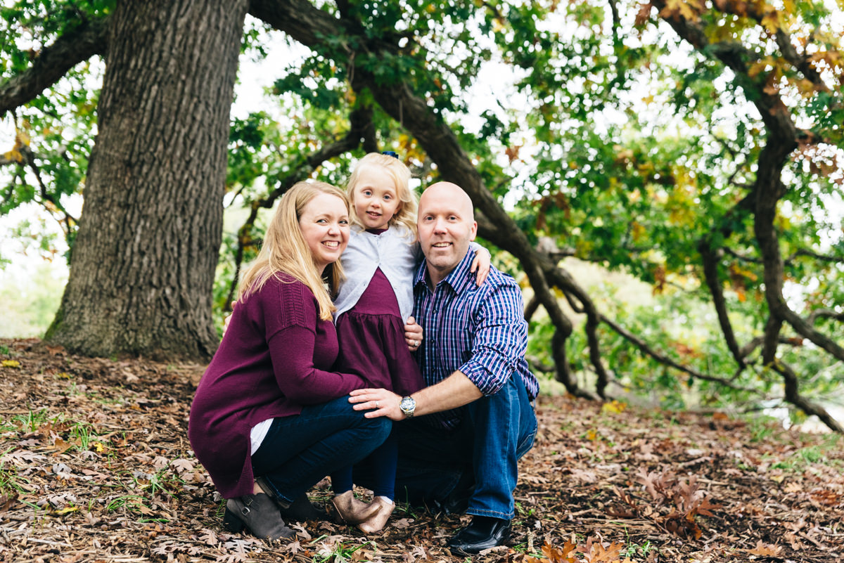 Family poses for photo at Minnesota Landscape Arboretum session.