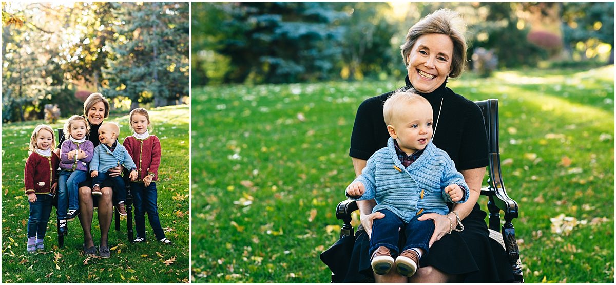 Grandmother plays with granddaughters and grandsons while sitting in a chair during Edina MN photos.