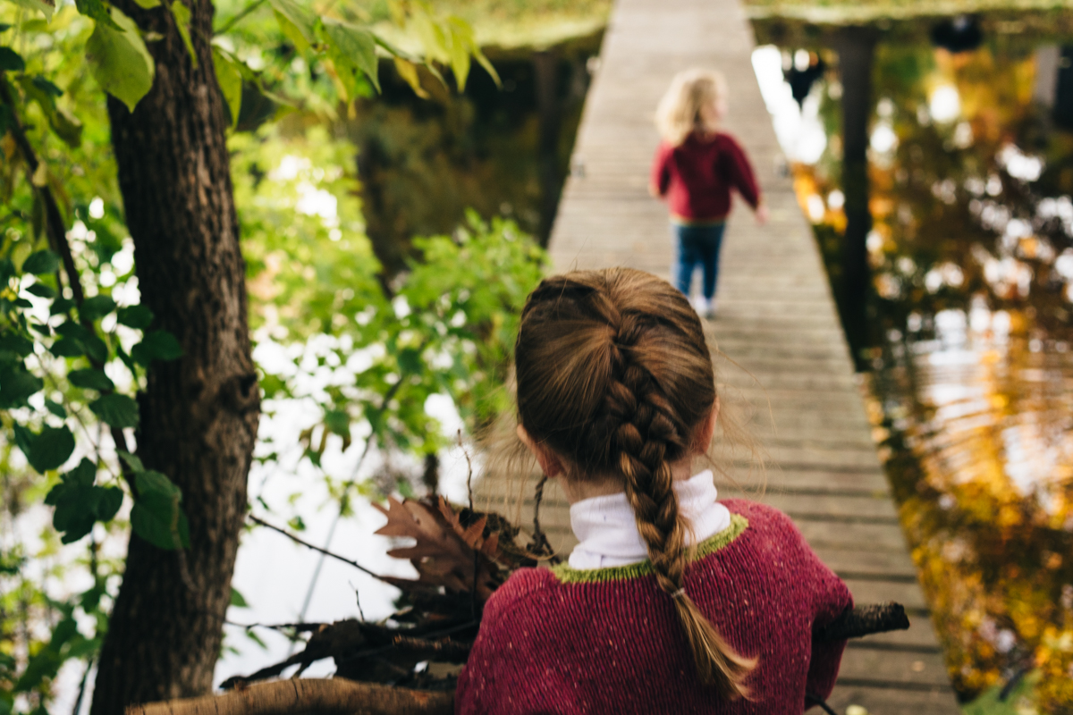 Two little girls walk down dock in Edina MN photo session.